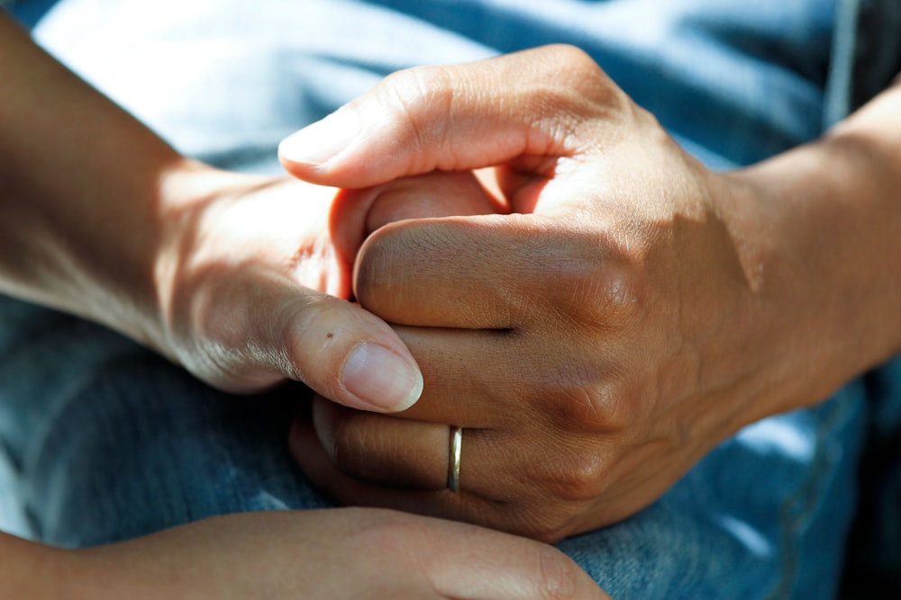 A trained caregiver sitting with an elderly person at home